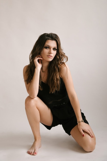 Portrait of a beautiful young sexy woman in a studio on a white background