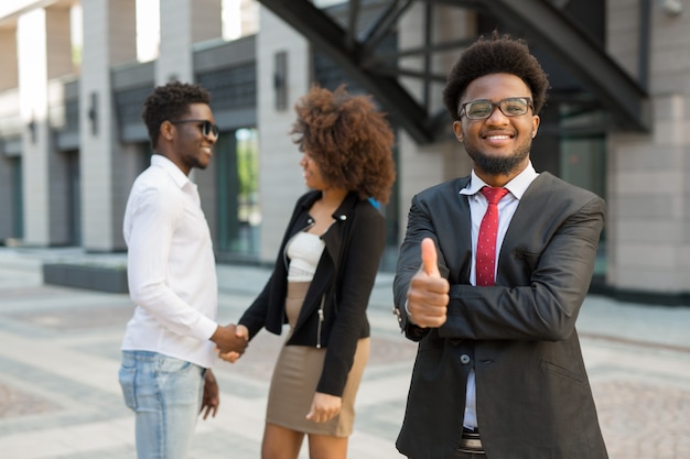 portrait of beautiful young successful people with hand gesture