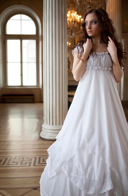 Portrait of a beautiful young victorian lady in white dress