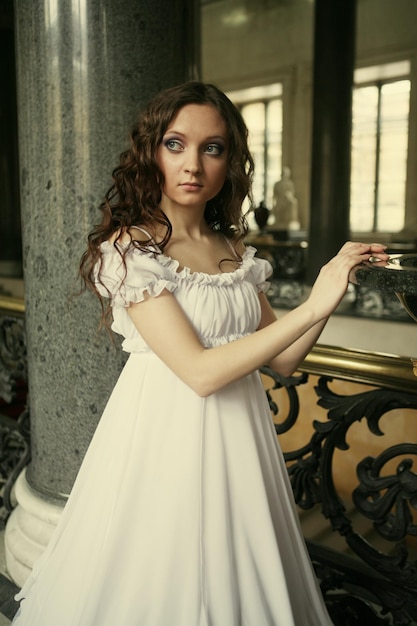 Portrait of a beautiful young victorian lady in white dress