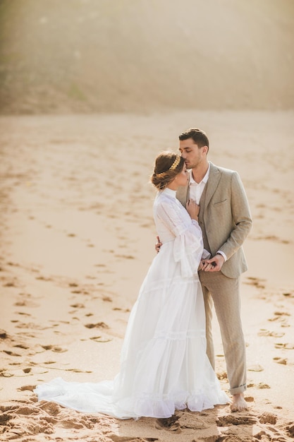 Portrait of beautiful young wedding couple on beach