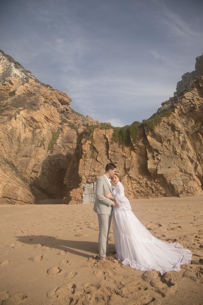 Portrait of beautiful young wedding couple on beach