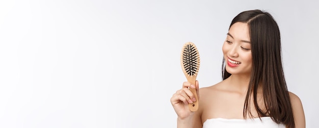 Portrait of a beautiful young woman comb wonderful hair isolated on white background asian beauty