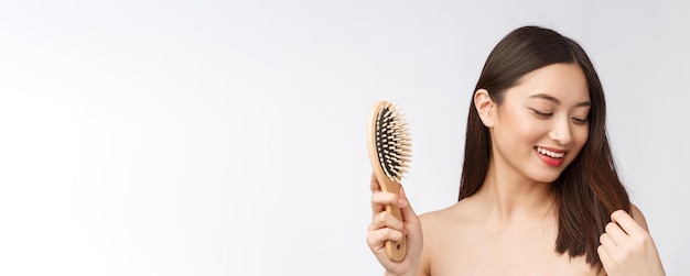 Portrait of a beautiful young woman comb wonderful hair isolated on white background asian beauty