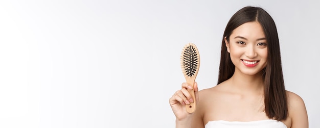 Portrait of a beautiful young woman comb wonderful hair isolated on white background asian beauty