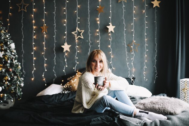 Portrait of a beautiful young woman in festive Christmas and New Year interior