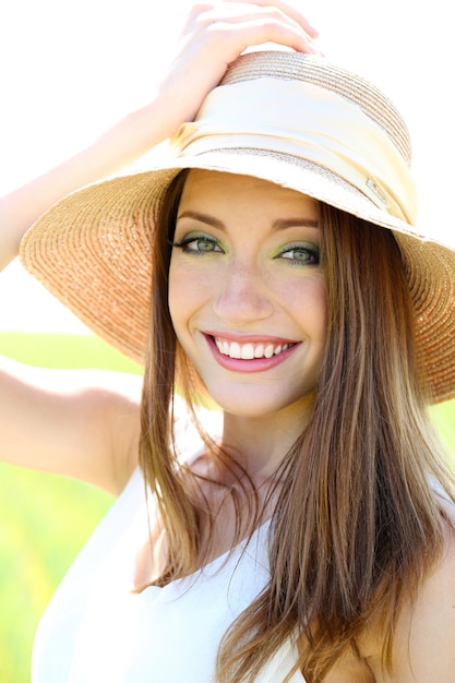 Portrait of beautiful young woman in the field