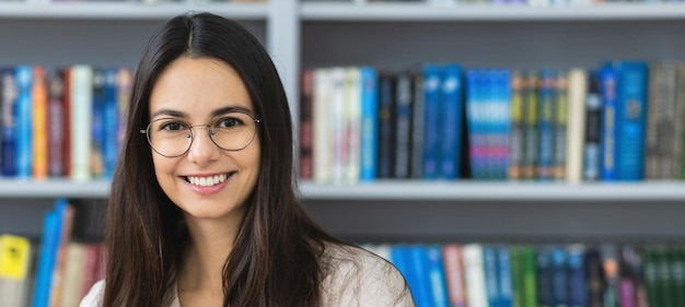 Portrait of a beautiful young woman in the library