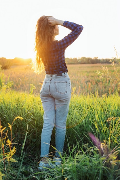 Portrait of a beautiful young woman on meadow