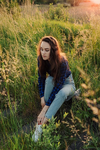 Portrait of a beautiful young woman on meadow