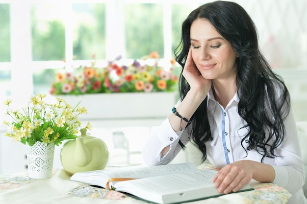 Portrait of beautiful young woman sitting at table