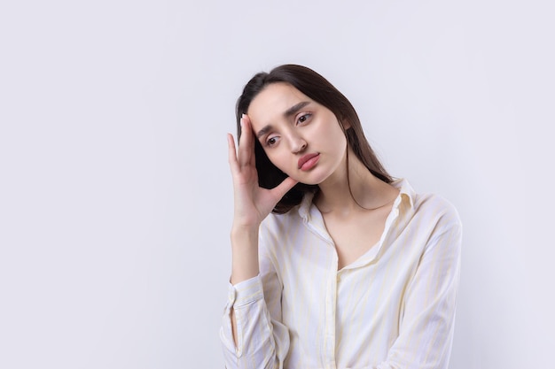 Portrait of a beautiful young woman thinking isolated on white background