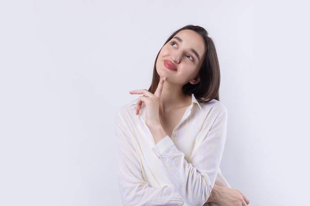 Portrait of a beautiful young woman thinking isolated on white background