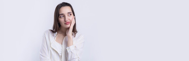 Portrait of a beautiful young woman thinking isolated on white background