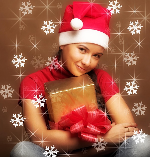 Portrait of beautiful young woman wearing santa claus hat with p