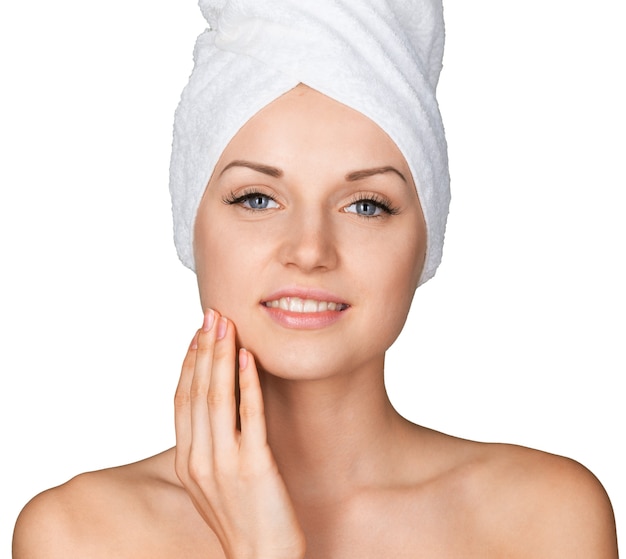 Portrait of beautiful young woman  in white towel on head on white background