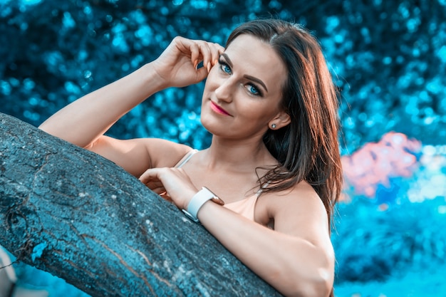 Portrait of a beautiful young woman with blue surroundings