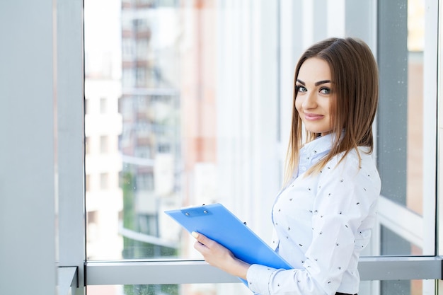 Portrait of beautiful young woman working in the office