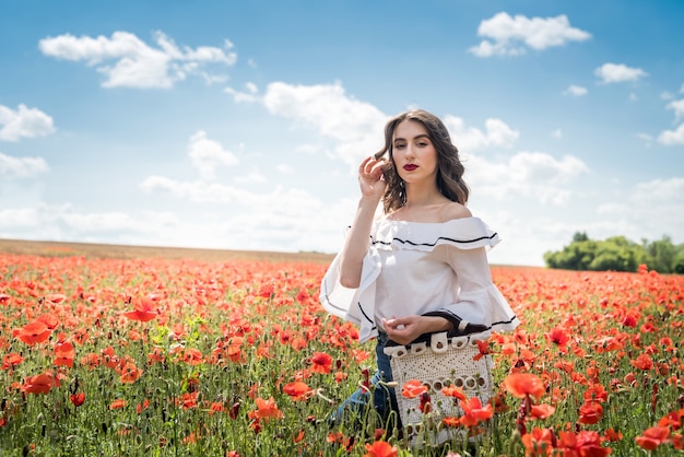 Portrait of beauty and fashion girl in poppy field. summer time