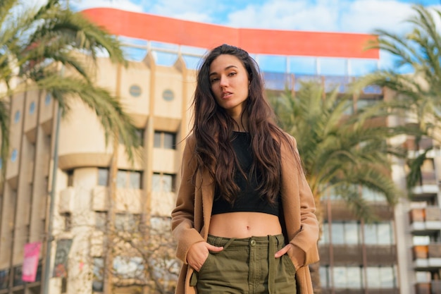 Portrait of a beauty serious young woman on the street looking at camera