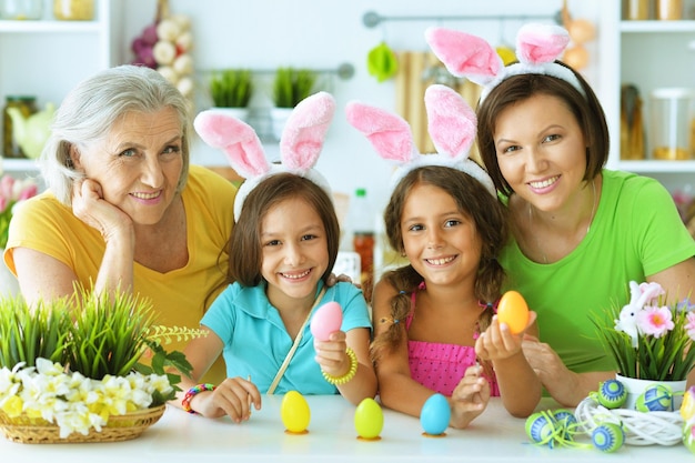 Portrait of big happy family painting traditional Easter eggs