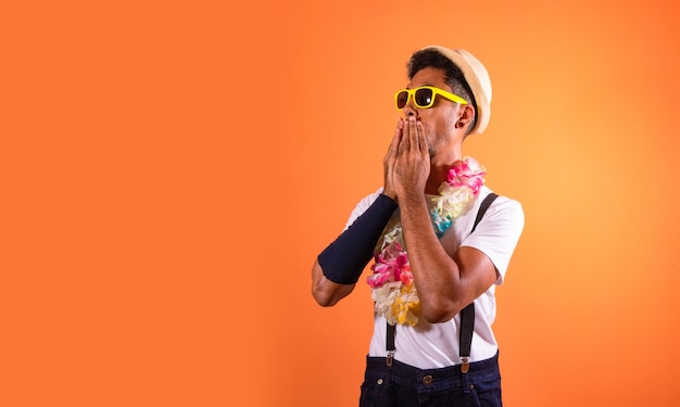 Portrait of Black Man With Carnival Props Isolated on Orange Background