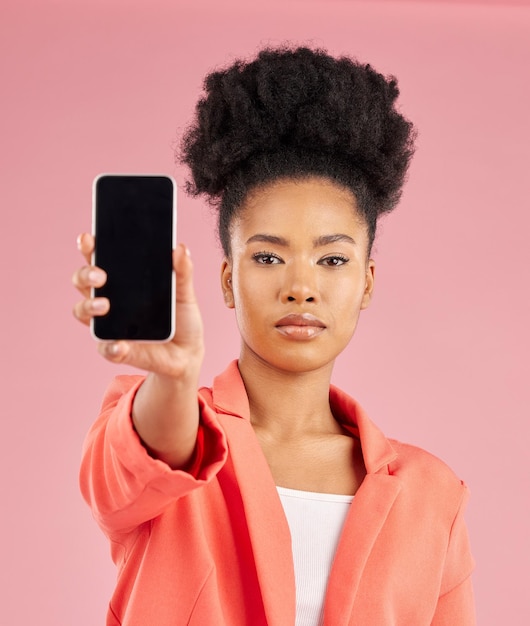 Portrait of black woman phone and screen in studio for contact info website promo or social media Cellphone mobile app and model on pink background with online news announcement offer or deal