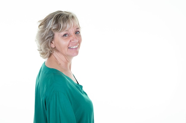 Portrait of blond senior woman in green sweater copy space on white background