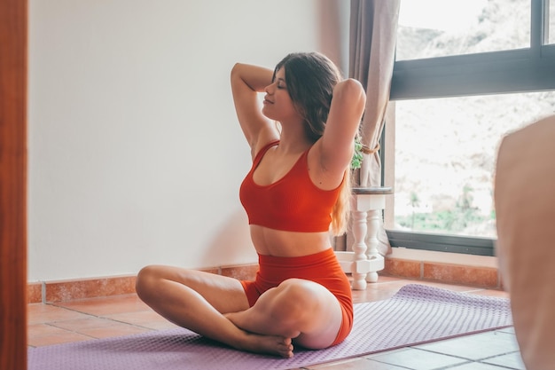 Portrait of blonde beautiful woman doing yoga and relaxing her mind and her body at home on the floor One active and heathy girl taking care of health training