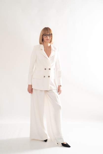 Portrait of blonde businesswoman confident on grey background