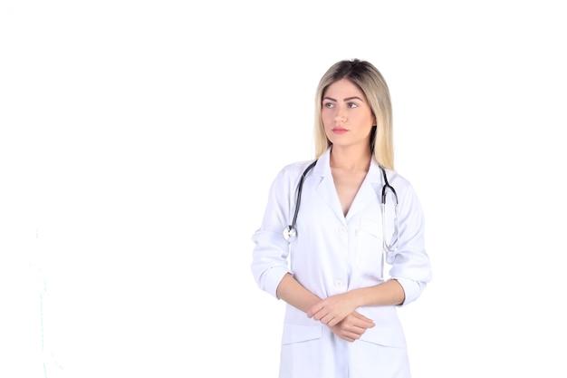 Portrait of blonde doctor on white background