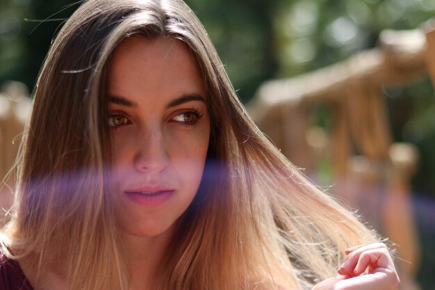 Portrait of blonde girl with intense eyes in the park