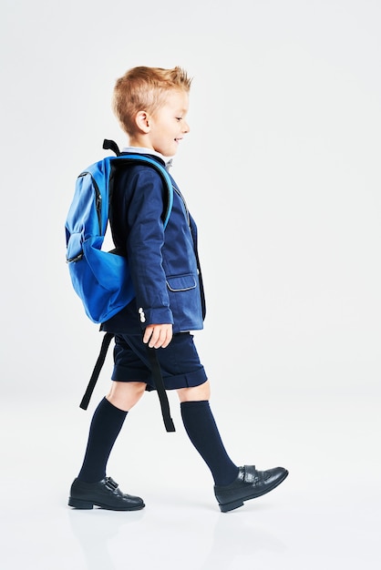 Portrait of a boy ready to school isolated on white