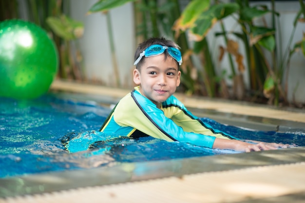 portrait boy swimming in the pool