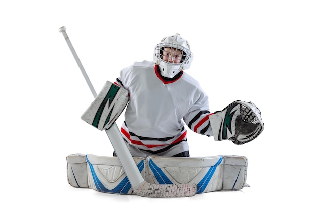 Portrait of boy teenager hockey player training in special protective uniform isolated over white studio background