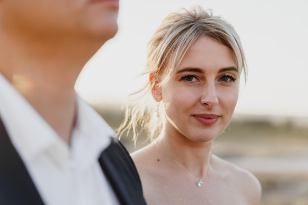 Portrait of a bride and groom in a sunset light