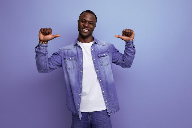 Portrait of bright confident young attractive african man dressed in stylish denim clothes