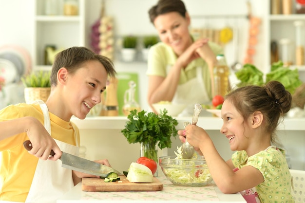 Portrait of brother and sister cooking together in kitchen