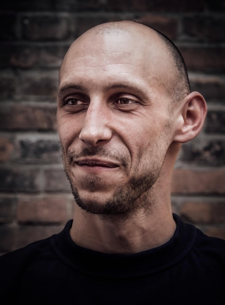 Portrait of a brutal young man with a smile on his face