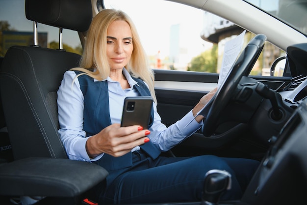 Portrait of business elegant middleaged woman in car