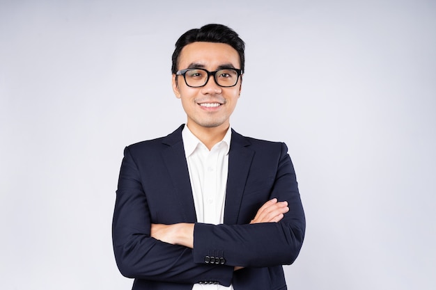 Portrait of business man wearing suit, isolated on white background