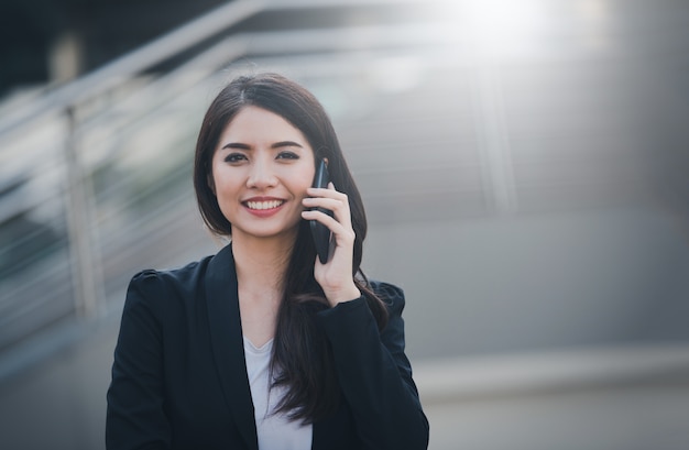 Portrait of business woman happy smile talking on smartphone