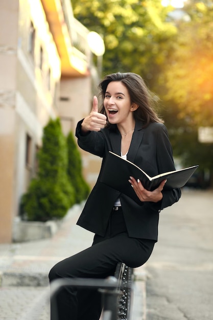 Portrait of business woman walking and smiling outdoor