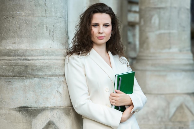 Portrait of a business woman with a notebook in her hand.