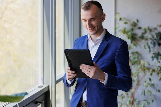 Portrait of a businessman holding a tablet