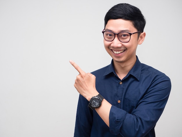 Portrait businessman smile gesture point finger at copy space