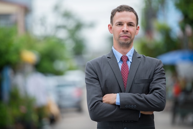 Portrait of businessman wearing suit in the streets outdoors