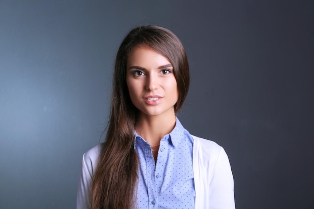 Portrait of a businesswoman against dark background Woman smiling Portrait of a woman