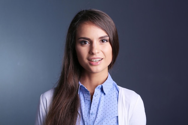 Portrait of a businesswoman against dark background Woman smiling Portrait of a woman