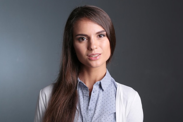 Portrait of a businesswoman against dark background Woman smiling Portrait of a woman